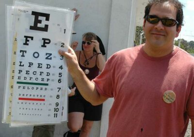 Man holding up vision test papers